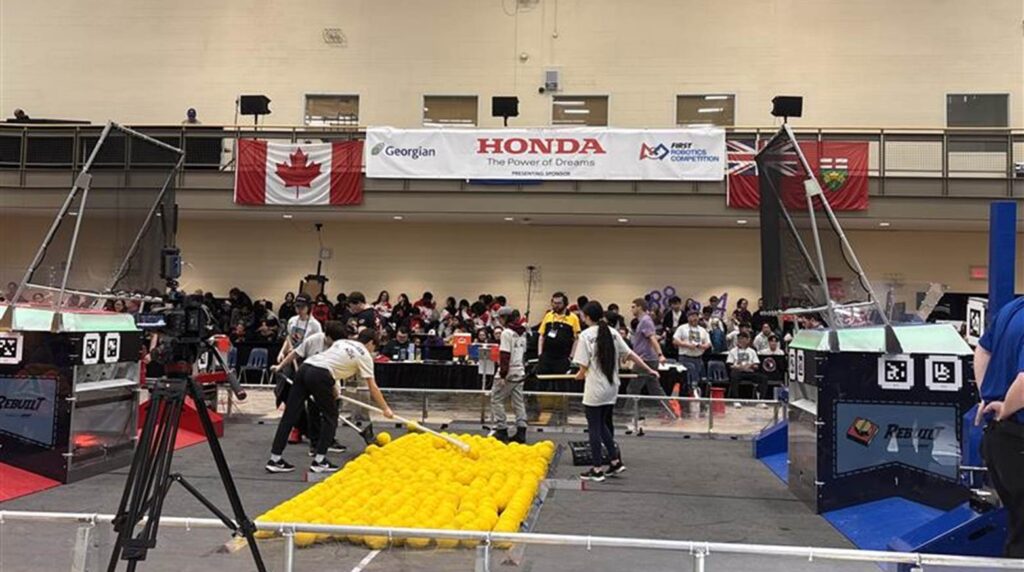 Students engaged in FIRST Robotics compeition.