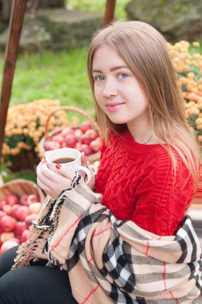Daria drinking tea, sitting in a garden