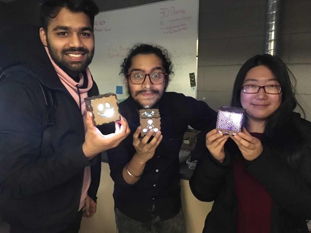 3 students showing off what they made at maker night