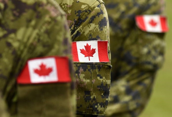 Canadian flags on military uniform.