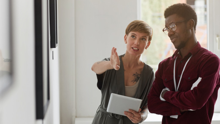 Two people looking at a whiteboard