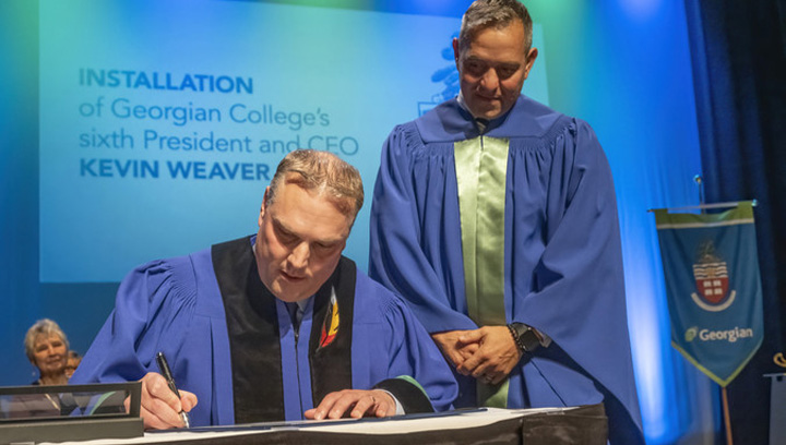 Kevin Weaver signs oath of office at installation as President and CEO