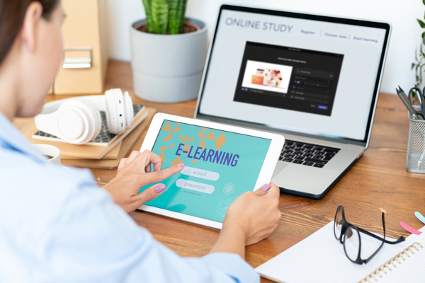 Young woman signing in to online workshop at desk