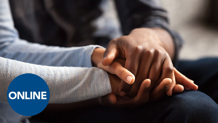 a person holding another's hands to comfort them