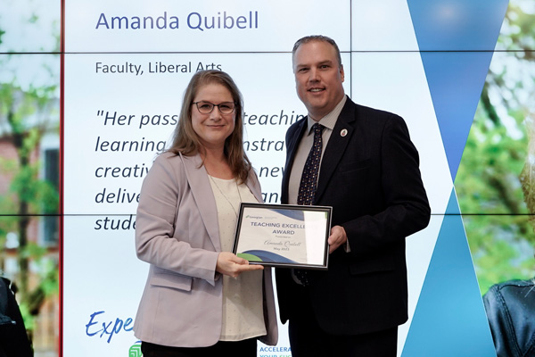 Amanda Quibell receiving her Teaching Excellence Award from Kevin Weaver