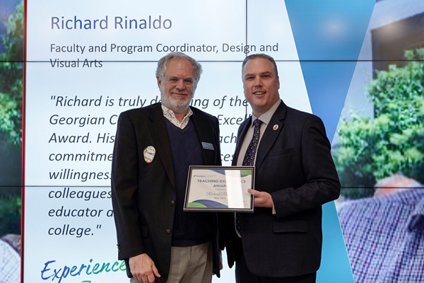 Richard Rinaldo receiving his Teaching Excellence Award from Kevin Weaver