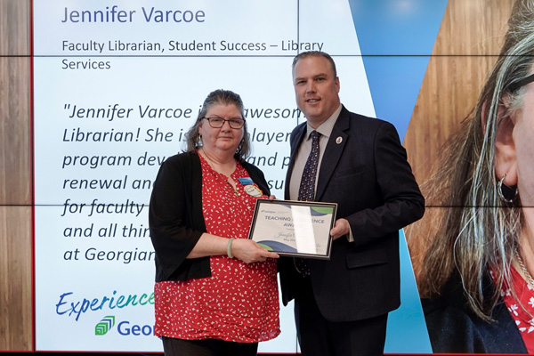 Jennifer Varcoe receiving her Teaching Excellence Award from Kevin Weaver