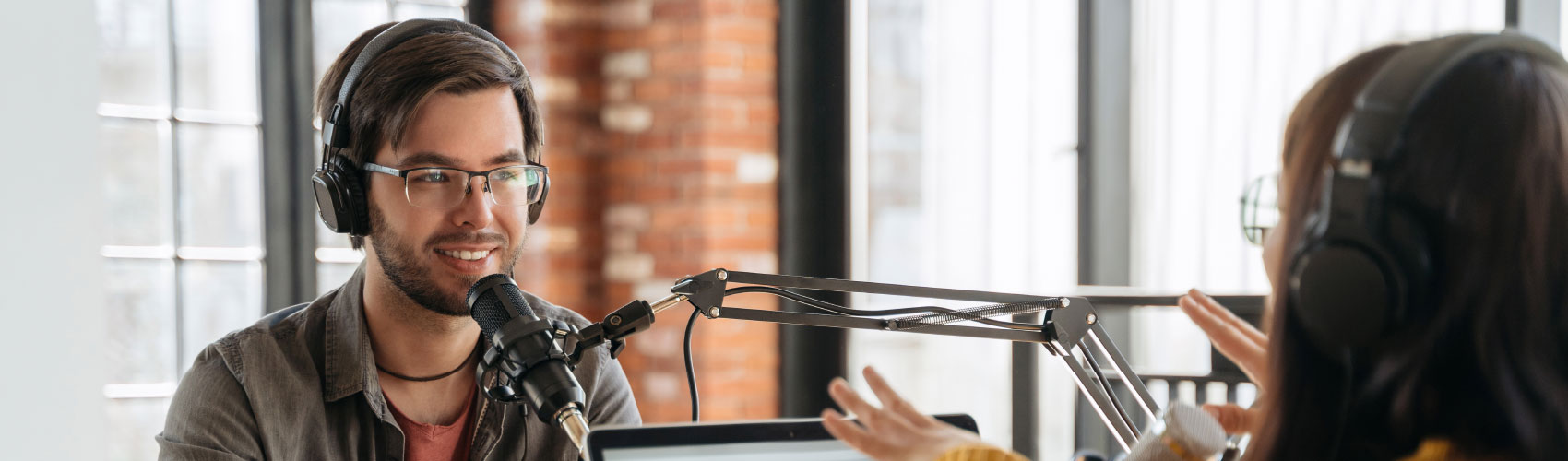 Two people talking during a podcast recording