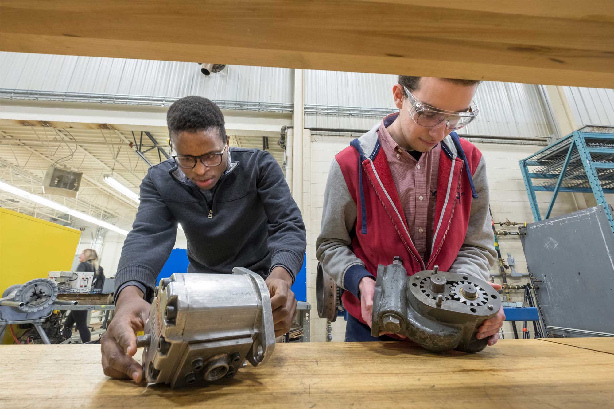 two male power engineering students at Georgian College working on machinery