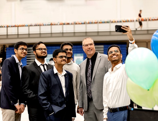 President and CEO Kevin Weaver engaging with students at orientation; taking a selfie