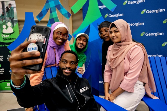 President and CEO Kevin Weaver with students who are taking a selfie at Orientation