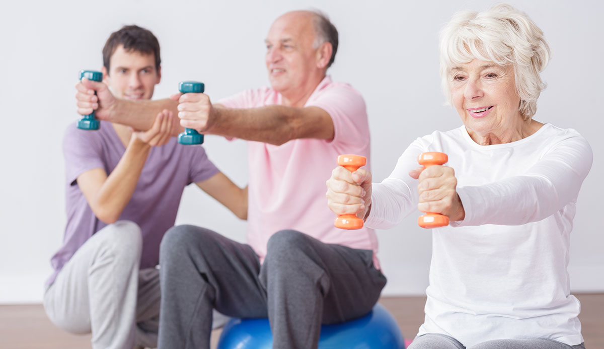 Trainer and clients doing exercises