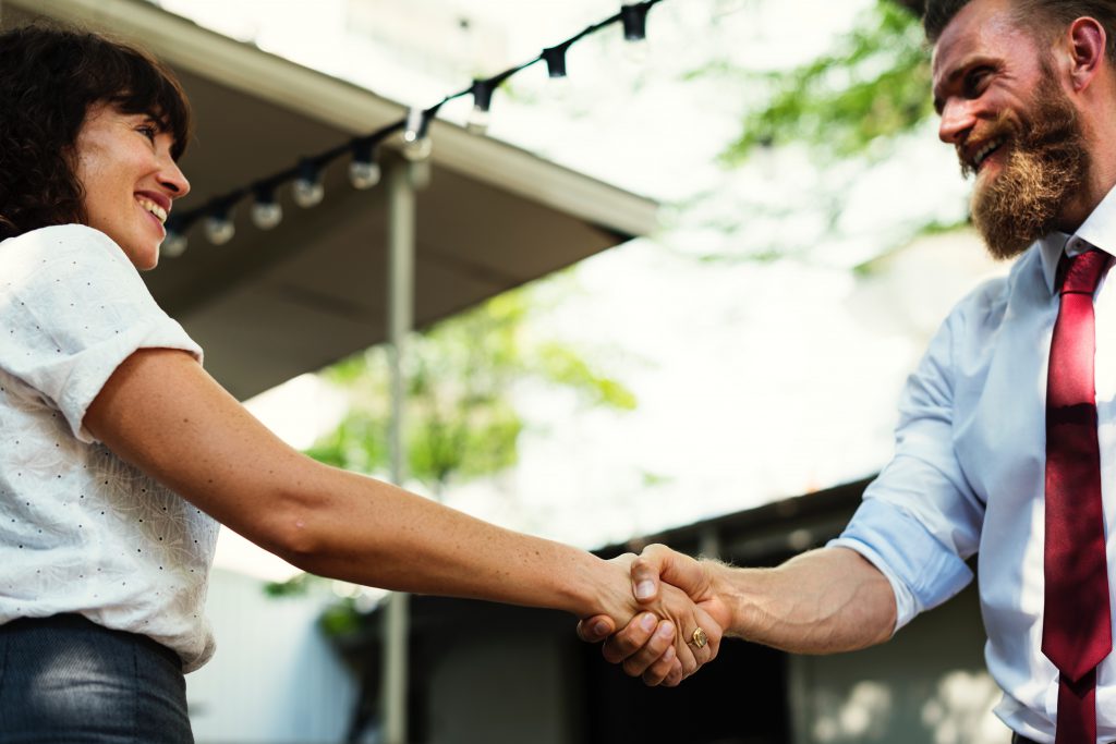 Handshake between woman and man in business attire