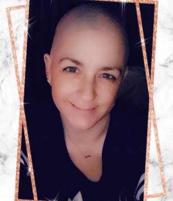 Robyn Haggart, Practical Nursing student, mom and cancer survivor, head shaved, selfie, smiling at camera wearing black t-shirt