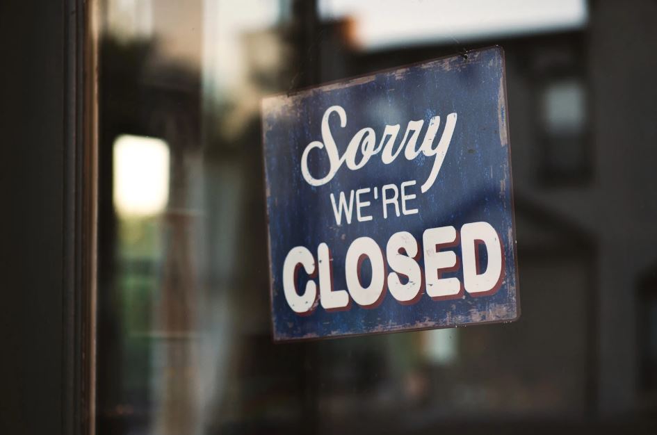 A sign that reads "Sorry we're closed" hangs in a window.