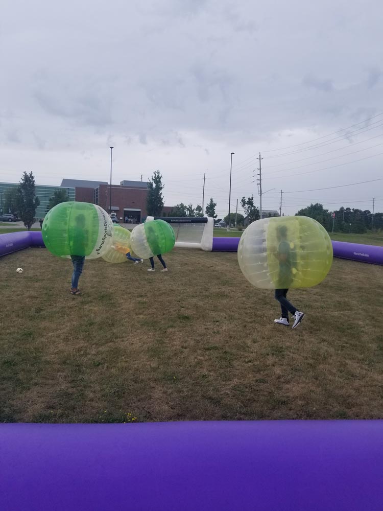 a group of students playing zorb soccer during fall 2019 orientation at Georgian's South Georgian Bay Campus