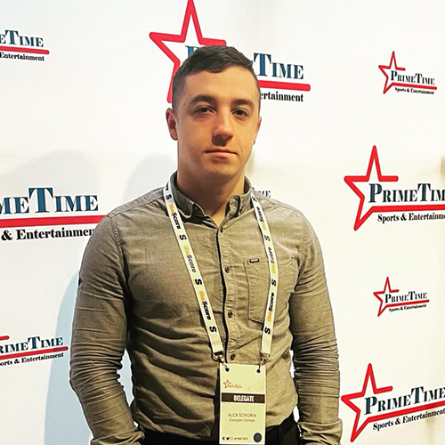Alexander Sorokine, student in Georgian College's two-year Sport Administration program, in front of a PrimeTime Sports & Entertainment backdrop while attending the conference
