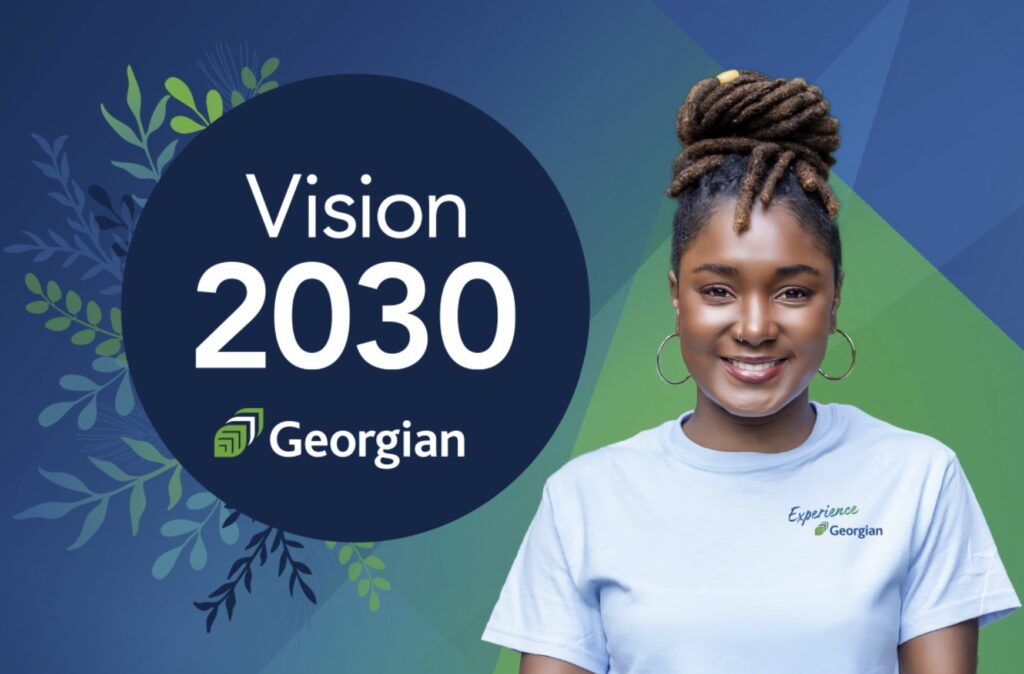 A person wearing a shirt that reads Experience Georgian. Additional text: Vision 2030 Georgian.