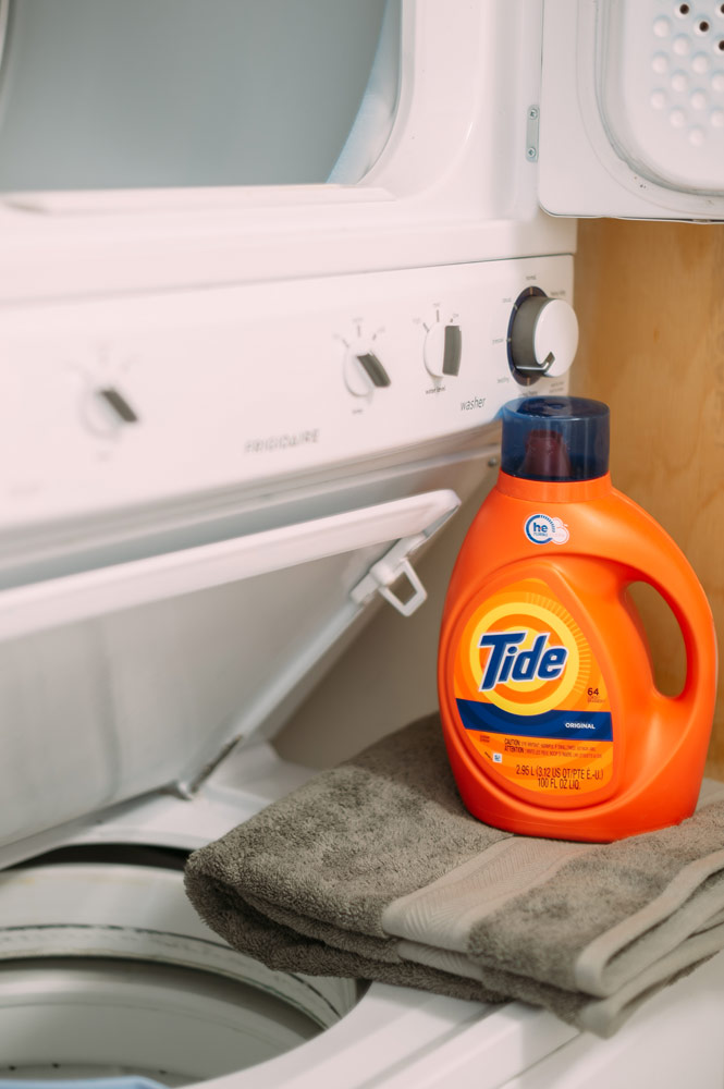 Detergent and towels on the stacked laundry facilities at the Georgian College Orillia Residence