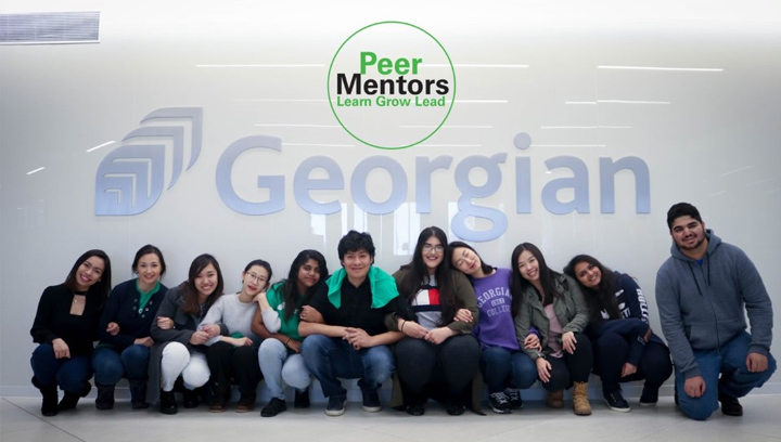 a group of peer mentors kneeling in front of a Georgian College logo