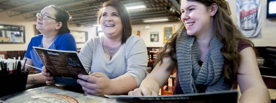 Three female students dining at The Den at the Orillia Campus