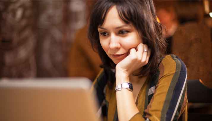 Woman working on a laptop at desk