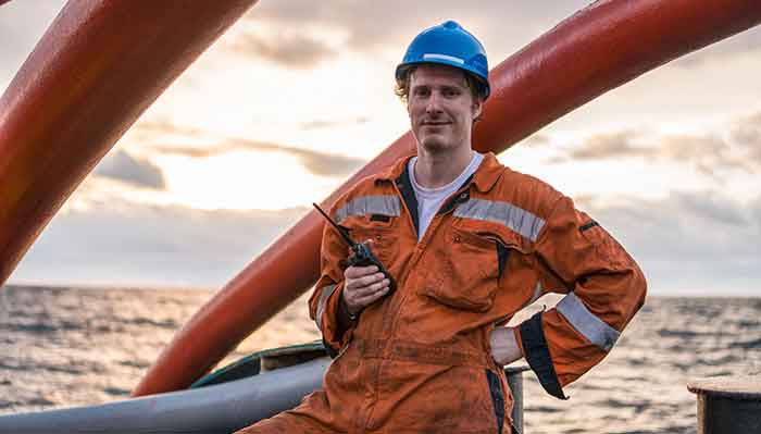 Professional ship engineer on deck with radio