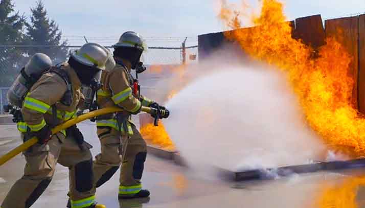 Fire crew in training fighting an open fire