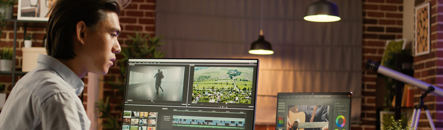 Person working at their desk with multiple screens