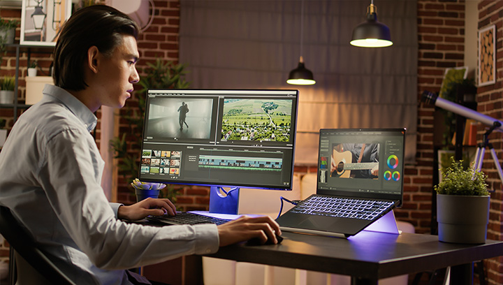 Person working at their desk with multiple screens